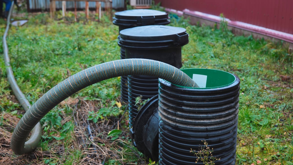 Septic technician servicing a system pump out on a rural Texas property